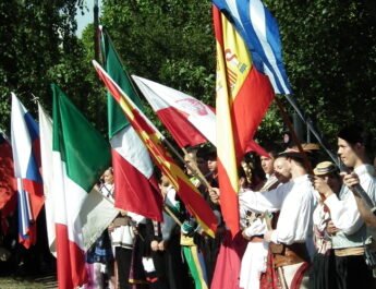 Grupo de personas con banderas en un festival de folclore