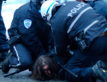 Polic铆as deteniendo a persona en el suelo