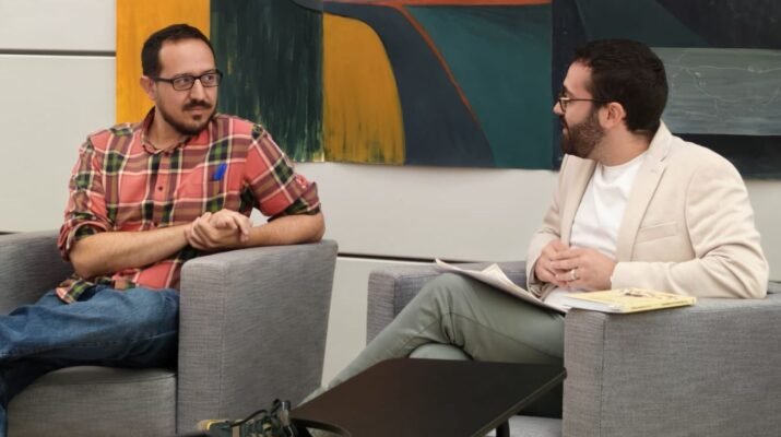 Escudero Paniagua y Silvestre Llamas están charlando, sentados en dos sillones grises, en la presentación del libro